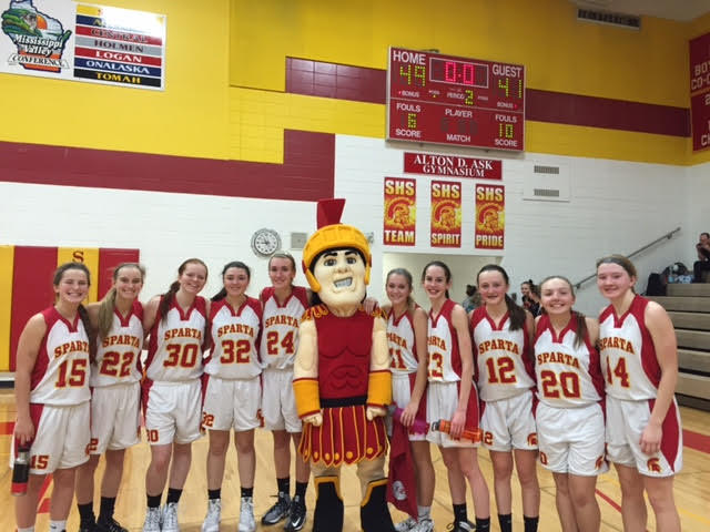 Spartan Man poses with the Sparta High School Girls Basketball team